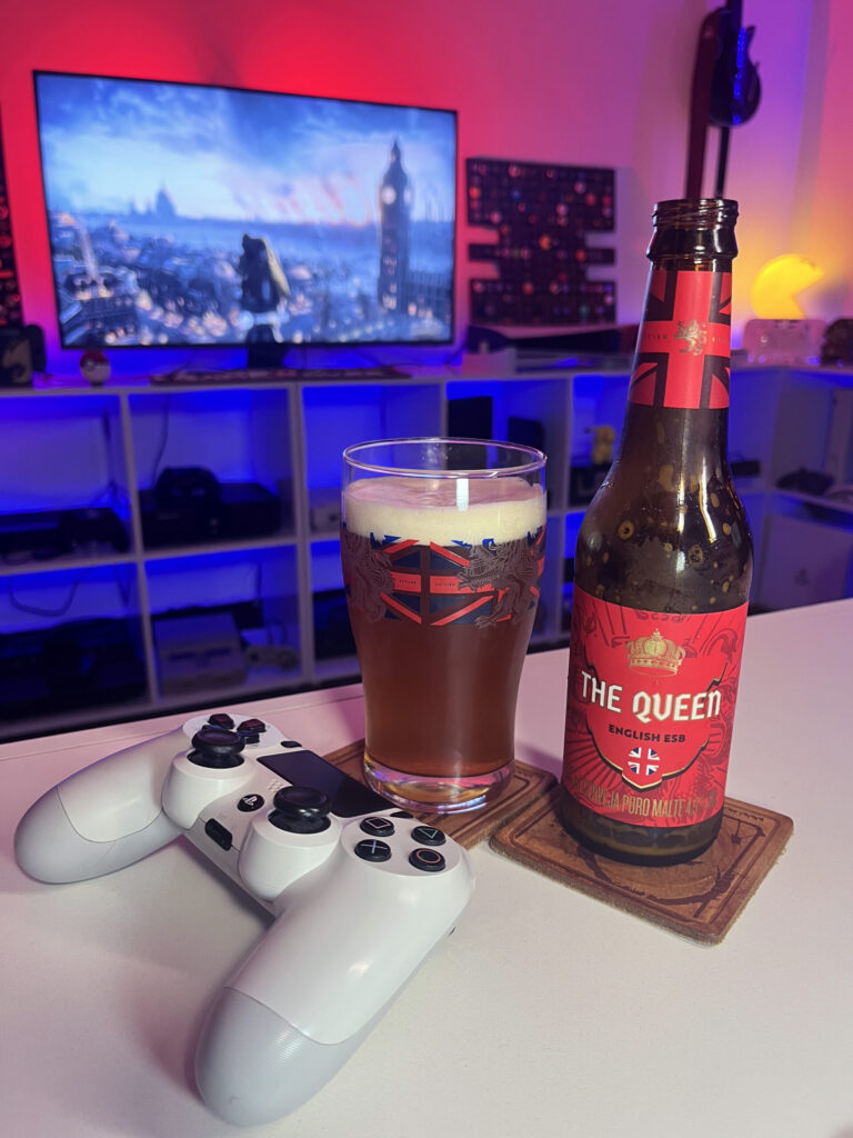 Cerveja The Queen da Caixa da Alegria ao lado de Assassin's Creed Syndicate
