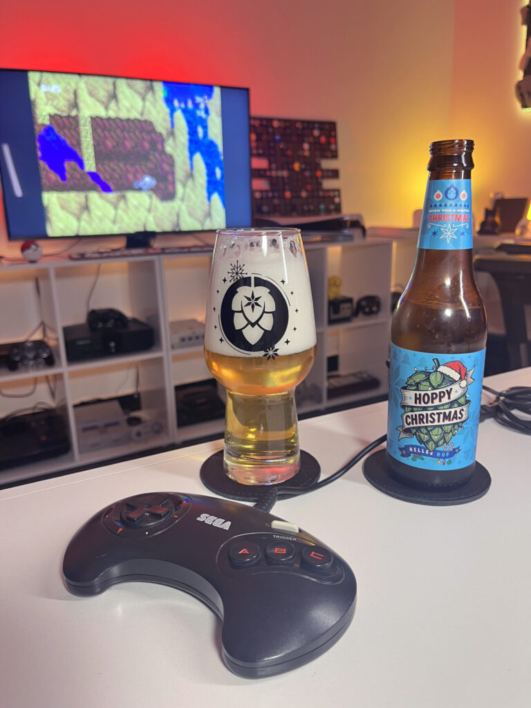 Cerveja Helles amarelo claro ao lado de Kid Chameleon no Mega Drive em clima de aventura leve.