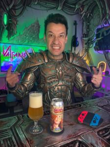 Cerveja West Coast Double IPA amarela ao lado de Valfaris no Nintendo Switch em clima de inferno sci-fi heavy metal.