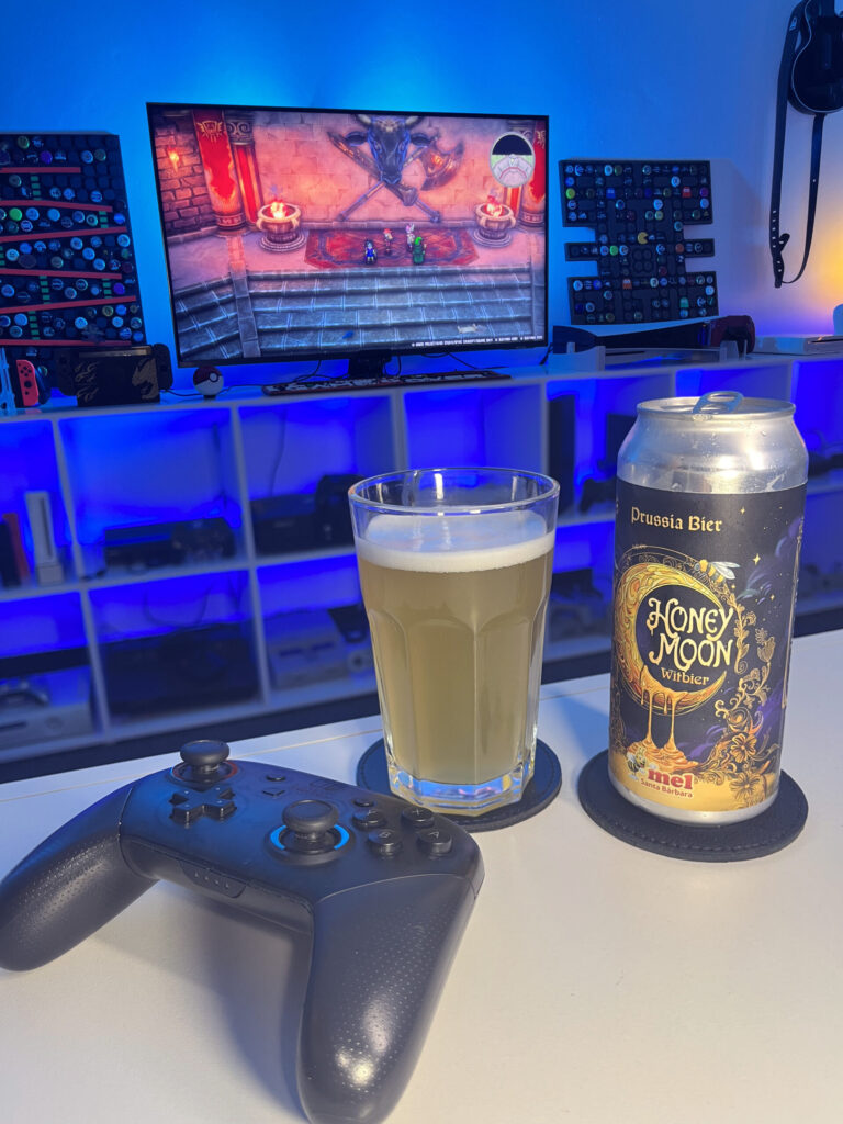 Cerveja Witbier clara e levemente turva ao lado de cena de Dragon Quest III HD-2D Remake no Nintendo Switch.