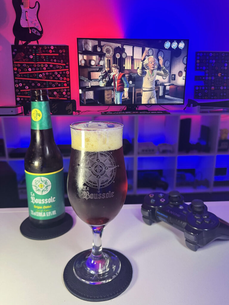 Belgian Dubbel da Caixa da Alegria ao lado de De Volta para o Futuro The Game no PlayStation 3.